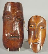 TWO AFRICAN CARVED WOOD MASKS, 21cm x 9.5cm and 16.5cm x 9cm.