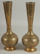 A PAIR OF QAJAR ENGRAVED BRASS BOTTLE VASES, decorated with various panels of birds and flora,