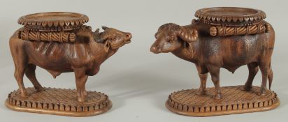 TWO FINE 19TH CENTURY ANGLO INDIAN CARVED WOODEN BUFFALO SHAPED COASTERS / STANDS, each approx. 24cm