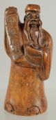 A CHINESE CARVED WOOD FIGURE OF A SAGE, 8.5cm high.