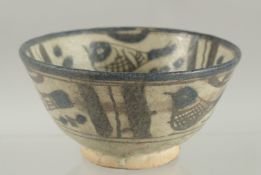 A 19TH CENTURY PERSIAN QAJAR SIGNED AND DATED POTTERY BOWL, 15cm high.