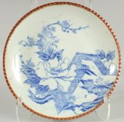 A JAPANESE BLUE AND WHITE IGEZARA PLATE, decorated with flora, 30cm diameter.