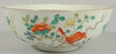AN EARLY 20TH CENTURT CHINESE FAMILLE ROSE BOWL, painted with flora and precious objects, the