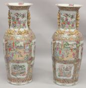 AN IMPRESSIVE PAIR OF CHINESE CANTON FAMILLE ROSE PORCELAIN FLOOR-STANDING VASES, beautifully