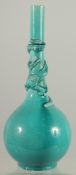 A CHINESE TURQUOISE GLAZE BOTTLE VASE, with carved relief dragon coiled around the neck, 28cm high.