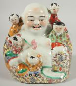 A CHINESE PORCELAIN HAPPY BUDDHA with surrounding children, impressed mark to base, 21cm high.