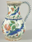 AN OTTOMAN TURKISH GLAZED POTTERY WATER JUG, with floral decoration, 24cm high.