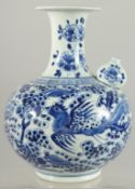 A FINE CHINESE BLUE AND WHITE PORCELAIN KENDI, painted with exotic birds and flora, 26cm high.