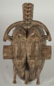 AN AFRICAN TRIBAL DOUBLE-HEADED CHILD MASK, 27cm x 16cm.