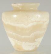 AN EGYPTIAN CARVED ALABASTER VASE, 11cm high.