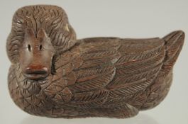 A CHINESE CARVED WOOD FIGURE OF A DUCK, with inset bone character mark, 9cm long.