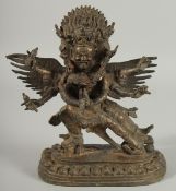 A TIBETAN BRONZE FIGURE OF A THREE-HEADED DEITY, 24.5cm high.