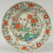 AN EARLY 20TH CENTURY CHINESE EXPORT WUCAI PORCELAIN DISH, painted with bird and native flora, 29.