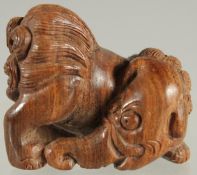 A CHINESE CARVED WOOD NETSUKE OF A BEAST, 4cm wide.