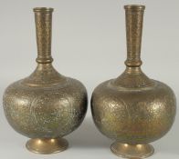 A PAIR OF INDIAN ENGRAVED AND CHASED BRASS VASES, 28cm high.