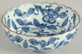 A CHINESE BLUE AND WHITE PORCELAIN BOWL, with ribbed exterior and petal form rim, decorated with