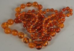 A STRING OF CHINESE AMBER BEADS.