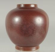 A CHINESE MOTTLED RED GLAZE JAR, character mark to base, 15.5cm high.