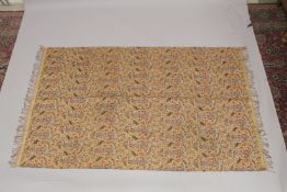 A 19TH CENTURY SAFAVID STYLE TEXTILE, depicting a repeated pattern of a courtier holding a wine