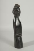 AN AFRICAN CARVED WOOD STANDING FIGURE, 33cm high.