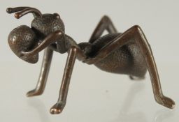 A BRONZE FIGURE OF AN ANT.