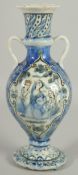 A 19TH CENTURY PERSIAN QAJAR GLAZED POTTERY VASE, with twin handles and painted with a panelto