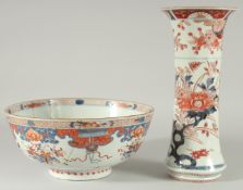 A LARGE JAPANESE IMARI PORCELAIN BOWL, (af), together with an Imari porcelain vase, (2).