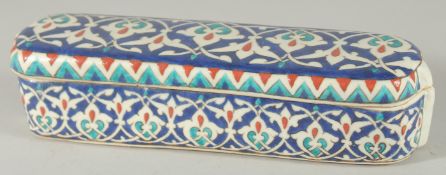 AN OTTOMAN TURKISH IZNIK GLAZED POTTERY PEN BOX, 23cm long.