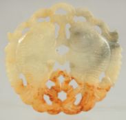 A CHINESE JADE AMULET, pierced and carved with mirrored fish, 5.5cm x 6cm.