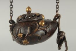 A CHINESE GILDED BRONZE HANGING CENSER AND COVER, with hanging monkey figure, 11.5cm wide.