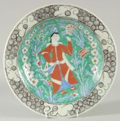 AN OTTOMAN TURKISH IZNIK DESIGN PLATE, painted with figure, 31cm diameter.
