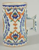 AN OTTOMAN TURKISH GLAZED POTTERY TANKARD, with floral motif decoration, 20.5cm high.