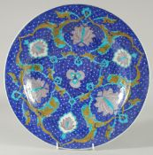 AN OTTOMAN TURKISH IZNIK PLATE, painted with floral motifs, 36cm diameter.