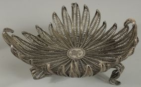 A TURKISH WHITE METAL FILIGREE BASKET, with central tughra, basket raised on four curving feet, 23.