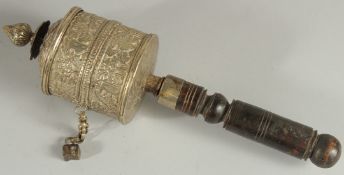 A TIBETAN EMBOSSED SILVER PRAYER WHEEL CONTAINING SCROLL, 27cm long.