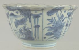 AN 18TH CENTURY NANKING CARGO BLUE AND WHITE PORCELAIN BOWL, decorated with panels of flora and