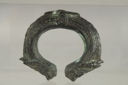 AN ARCHAIC BRASS BANGLE.