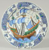 AN OTTOMAN TURKISH IZNIK PLATE, painted with a boat, 31cm diameter.