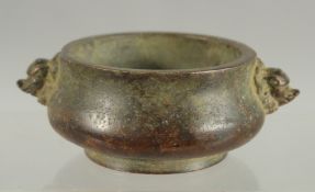 A SMALL CHINESE TWIN HANDLE BRONZE CENSER, 10cm wide.