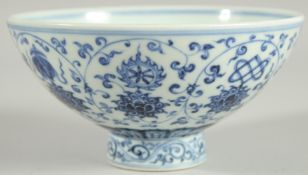 A CHINESE BLUE AND WHITE PORCELAIN FOOTED BOWL, painted with auspicious symbols, 15.5cm diameter.