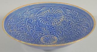 A CHINESE BLUE GROUND CARVED FLORAL BOWL, character mark to base, 20cm diameter.