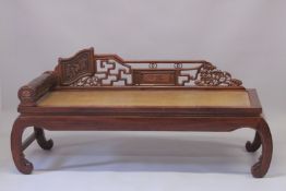A LARGE CHINESE LONG DAY BED with rolling head rest. 6ft long.
