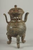 A CHINESE CARVED TWO HANDLED BRONZE CENSER AND COVER On three curving feet.. 12ins high.