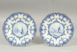 A ROYAL CROWN DERBY PAIR OF PLATES, the centres painted with sailing vessels, by W.E.J. DEAN..