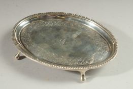 A GEORGE III SILVER OVAL TEAPOT STAND with bead edges, on four pad feet. 6ins x 4.5ins London