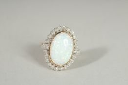 A 9CT GOLD OPAL AND DIAMOND OVAL RING.