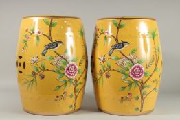 A GOOD PAIR OF CHINESE YELLOW PORCELAIN BARRELL SEATS decorated with birds. 18ins high.