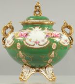 A FINE ROYAL CROWN DERBY VASE AND COVER painted with flowers above a green ground by A.F. WOOD.