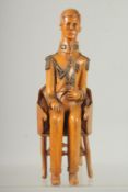 A RARE 19TH CENTURY CARVED BOXWOOD FIGURE OF NAPOLEON sitting in a chair. 9inshigh.