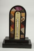 A DERBYSHIR ASHFORD THERMOMETER with coloured specimen marbles, black frame and thermometer. 5.75ins